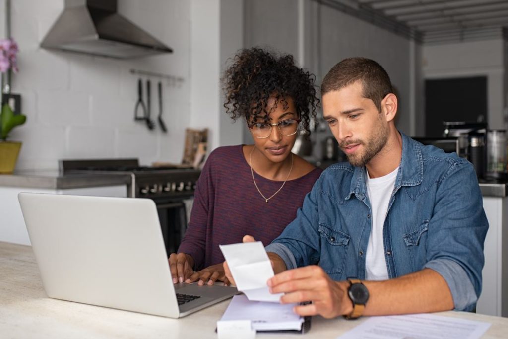 Married couple reviewing finances and paying bills