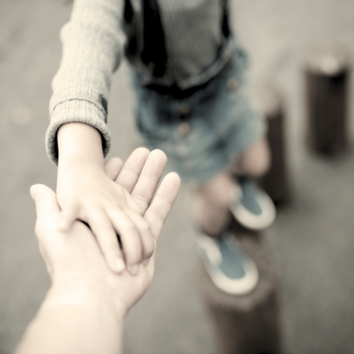 Child holding parent's hand